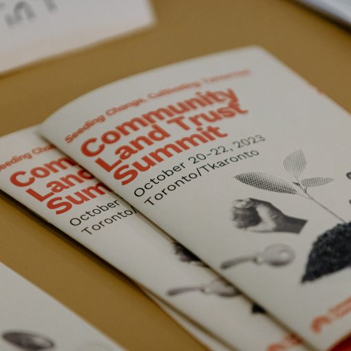 Photo of conference pamphlet that reads "Community Land Trust Summit"
